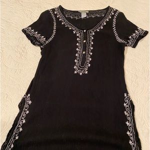 Black crepe like fabric with iridescent accents and side slits